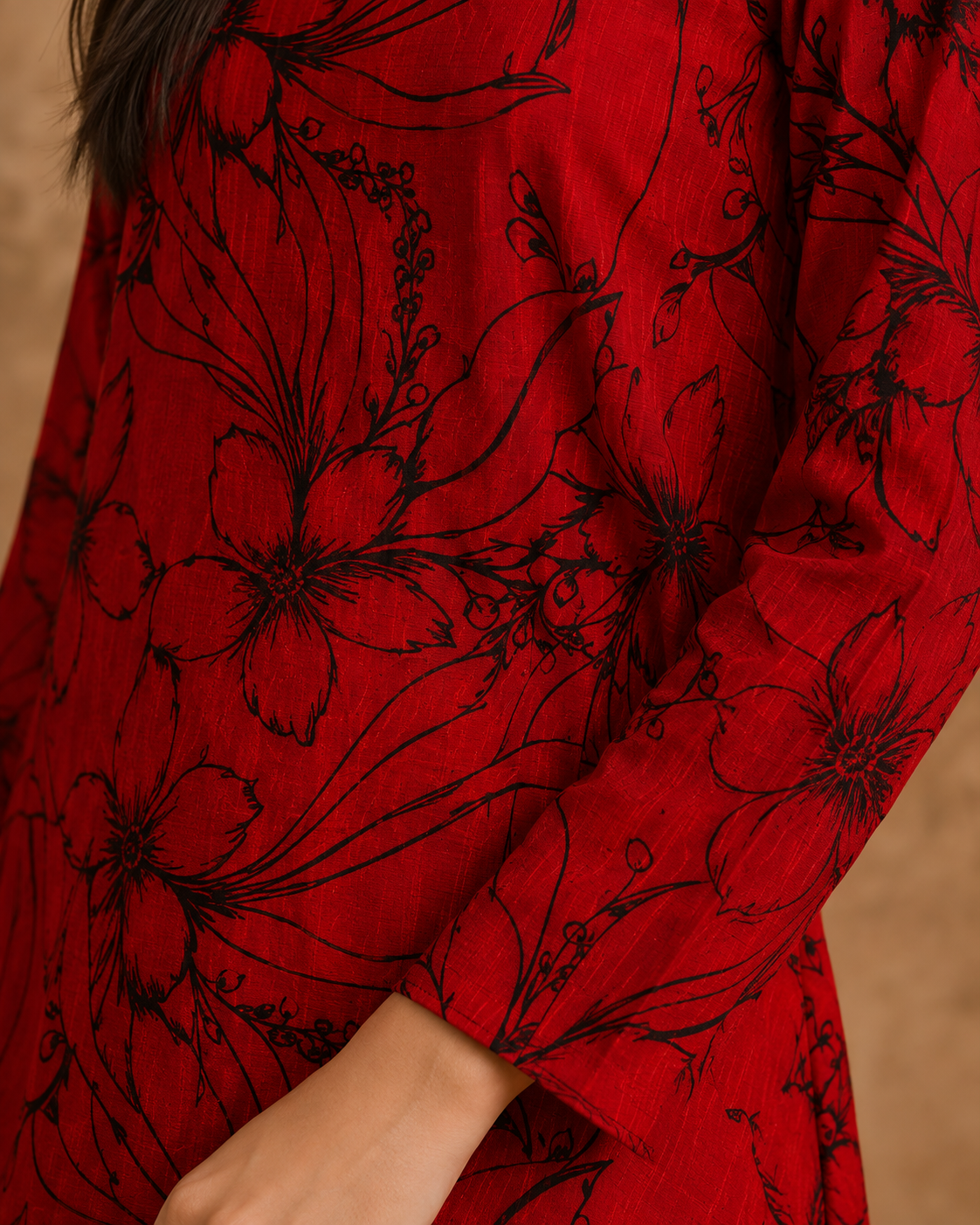 Model wearing a red floral Anarkali frock with black floral skirt
