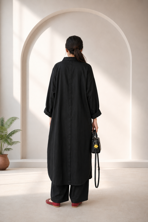 Back view of black pure lawn one-piece kurta showing the center pleat and rounded hem