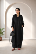 Close-up of cuffed sleeve and button detail on black pure lawn kurta