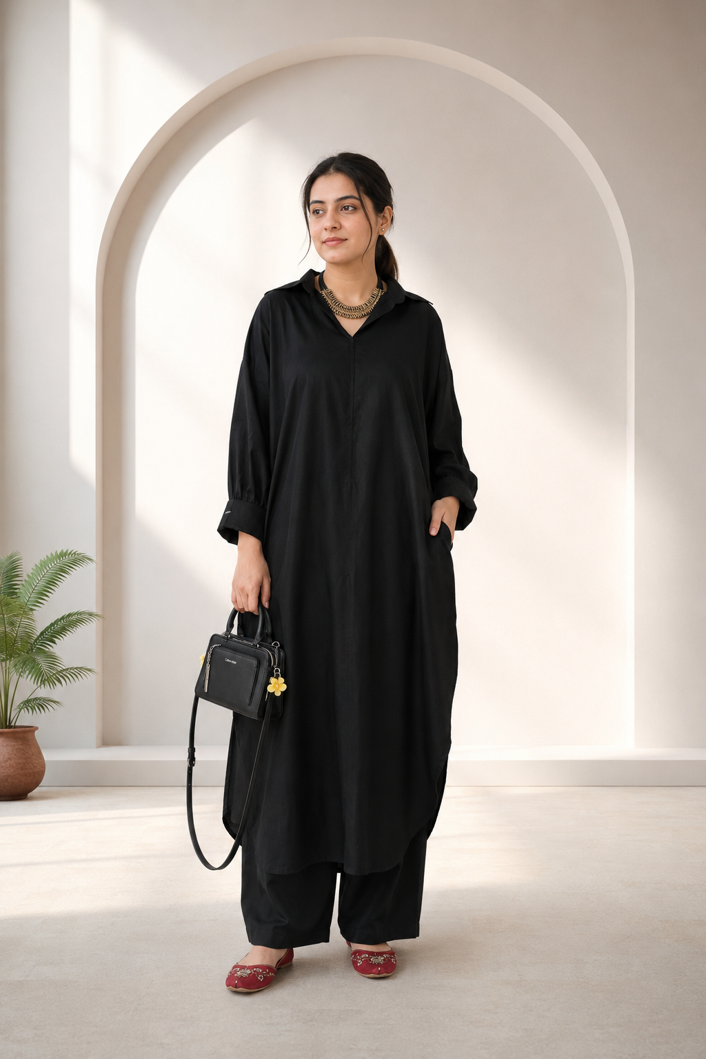 Close-up of cuffed sleeve and button detail on black pure lawn kurta