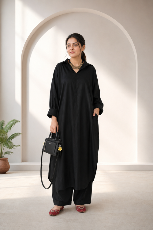 Close-up of cuffed sleeve and button detail on black pure lawn kurta