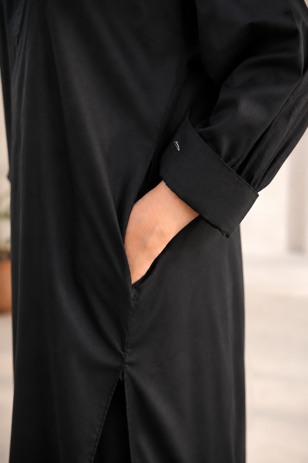Full-length front view of model wearing black pure lawn one-piece kurta