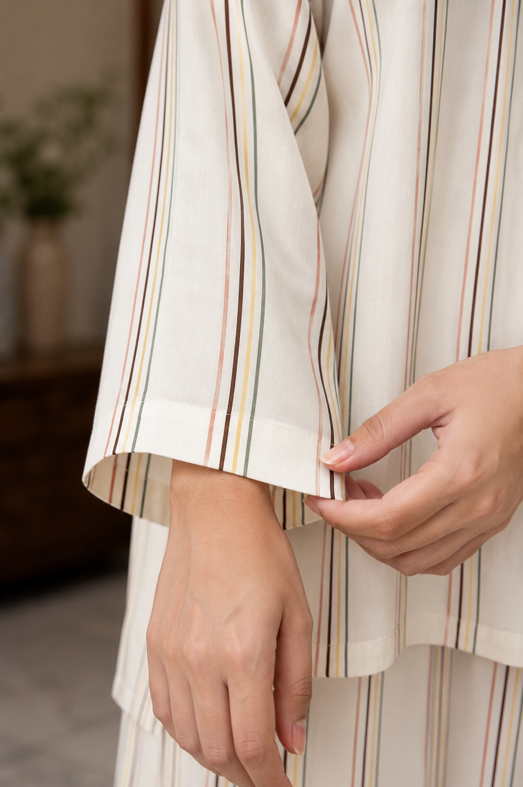 Detail of the flared-leg striped linen trousers and side pocket