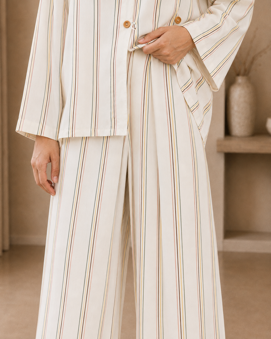 Close-up of the ivory striped linen neckline and button detail