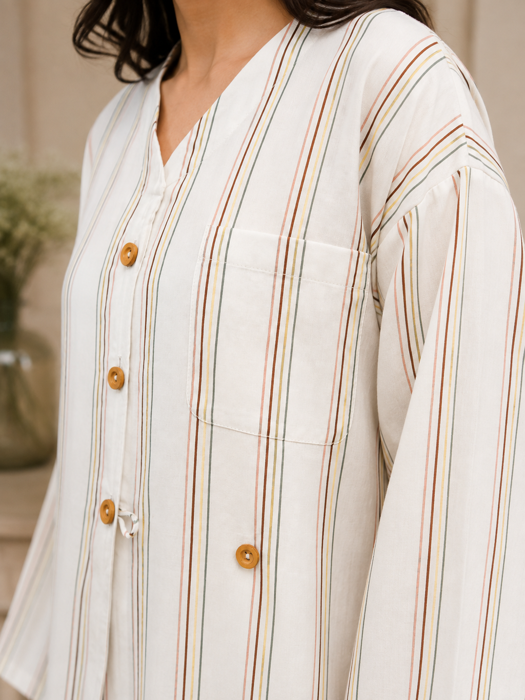 Close-up of the ivory striped linen top with button-front detailing