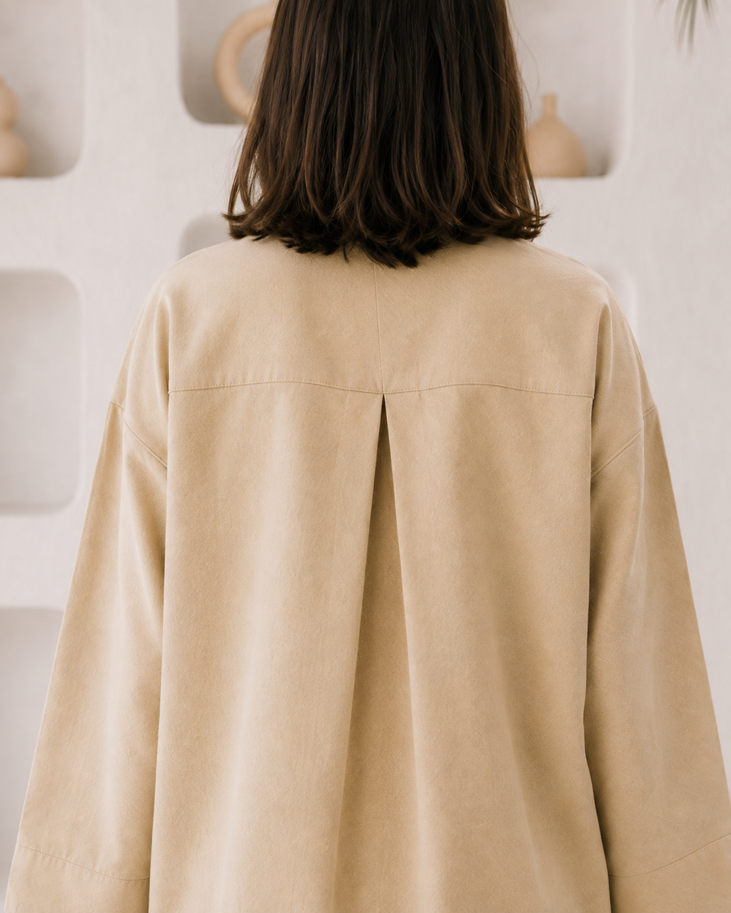 Close-up of round neckline and subtle V-opening with statement buttons