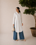 Back view of the ivory linen shirt and straight-leg trousers