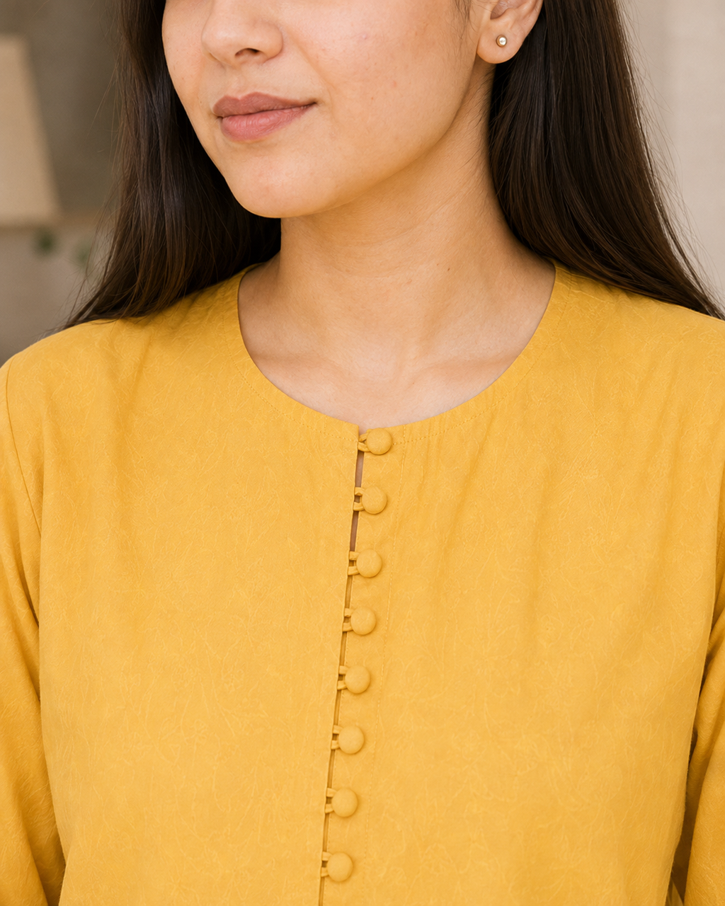 Model wearing mustard yellow Irish linen 2-piece co-ord set seated